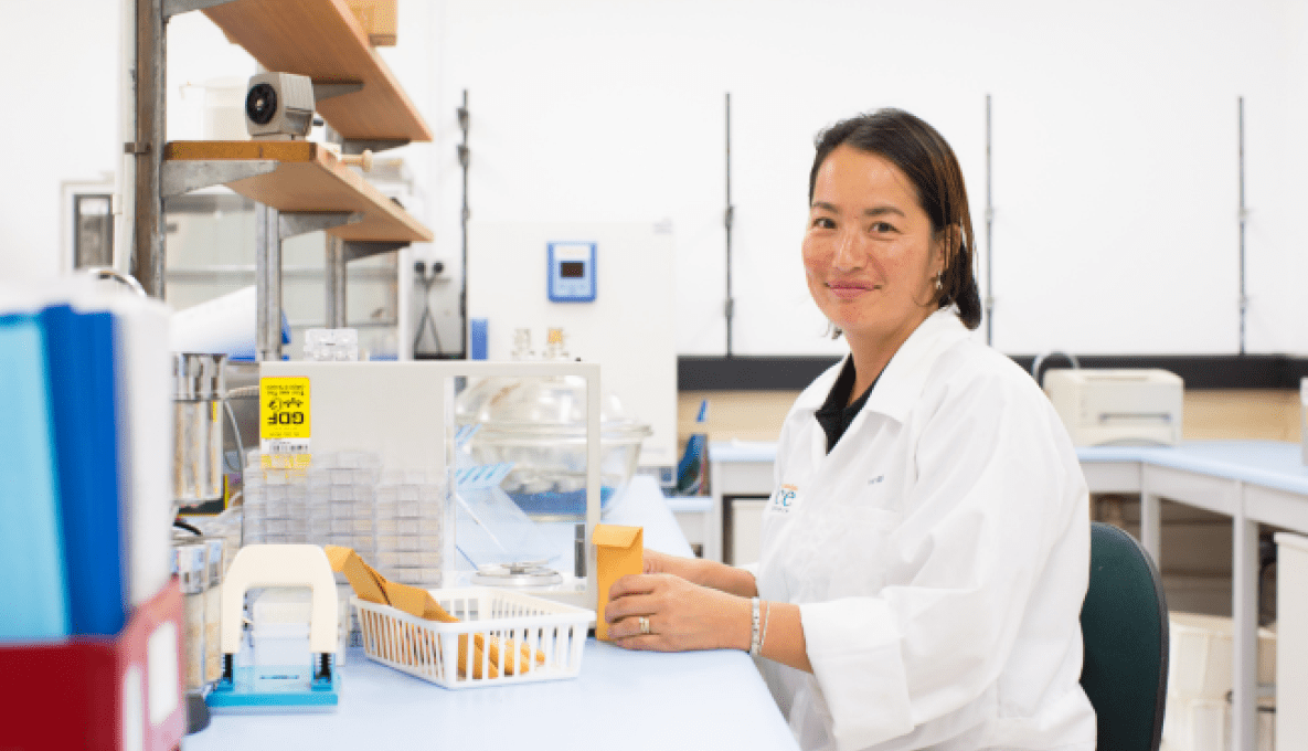 Researcher in a white coat in a lab