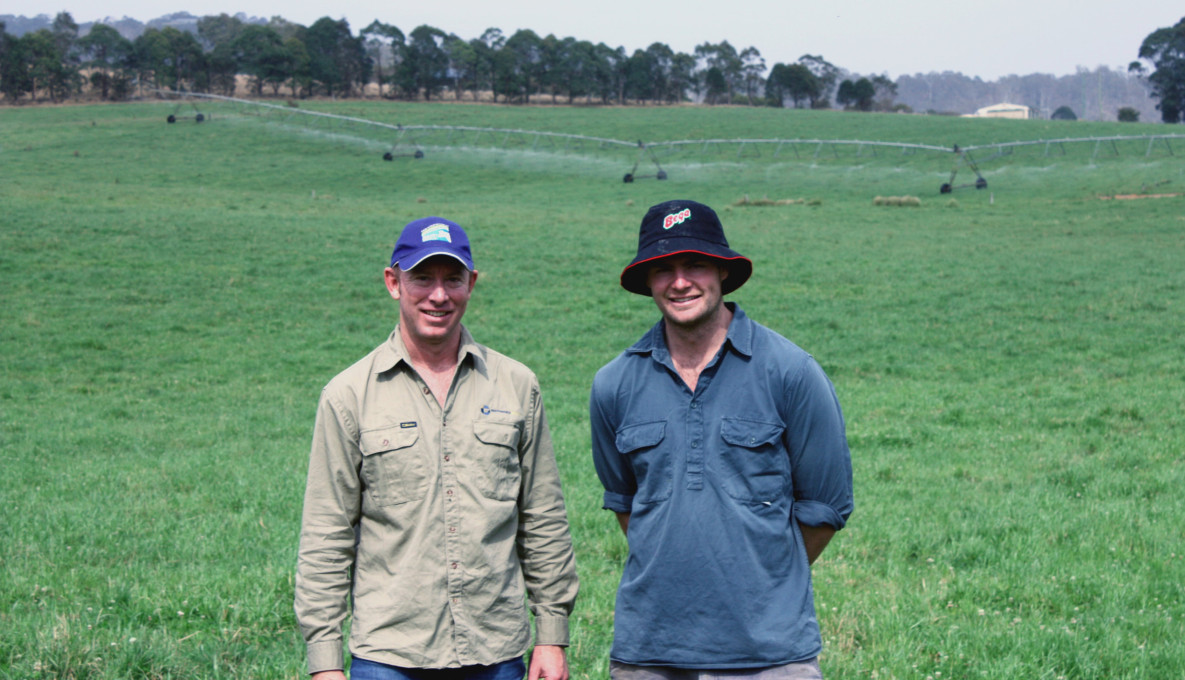 Farmer Will Russell and colleague in paddock with Irrigator in backgroud