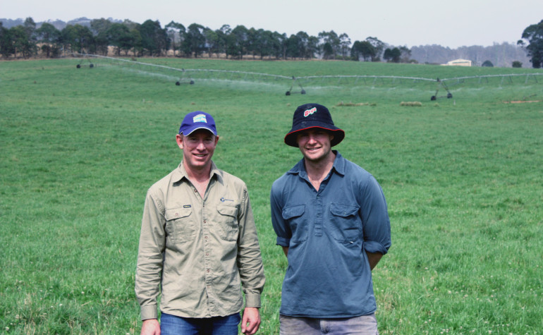 Farmer Will Russell and colleague in paddock with Irrigator in backgroud