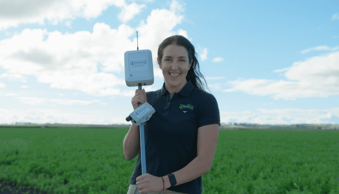 Alicia Garden, CEO, Goanna Ag holding a in-field sensors in a paddock