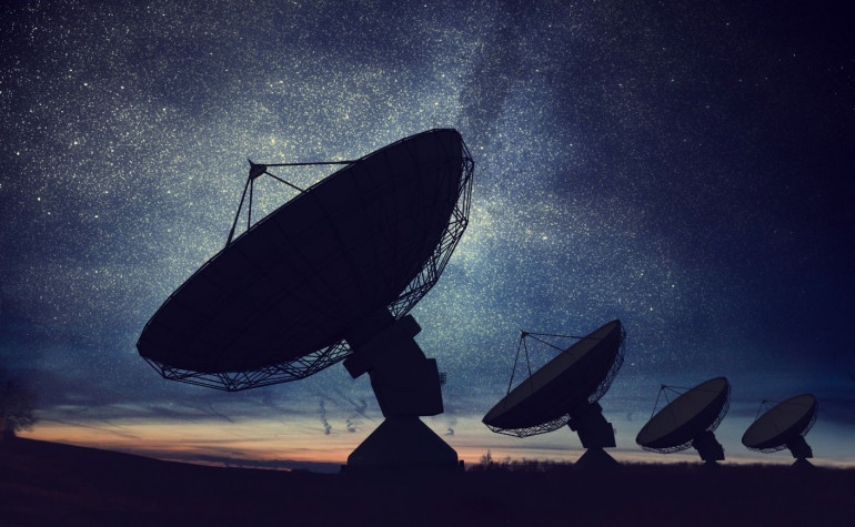 Giant satellite dish signal at dusk with the starry sky