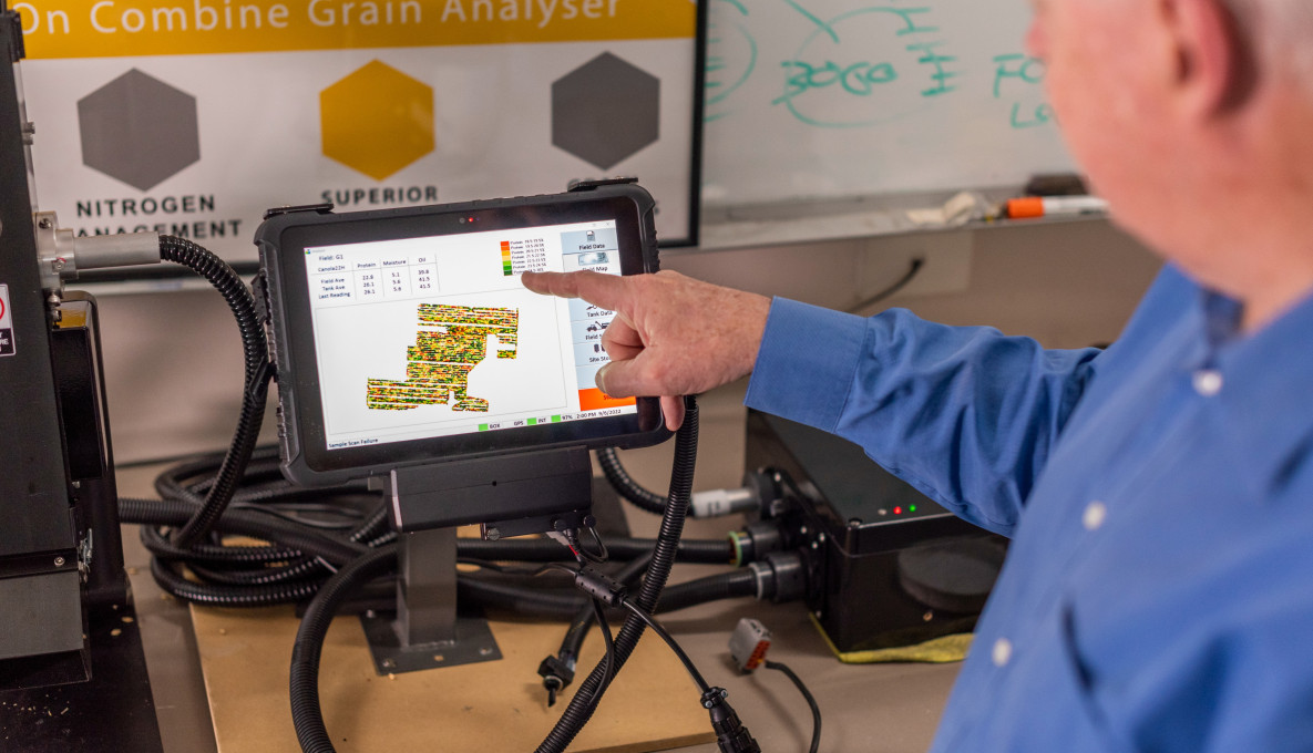 Phil Clancy pointing at screen of CropScan's cabin display technology