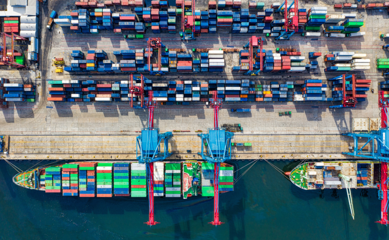 Ariel view of Cargo ships at Shipping dock and containers