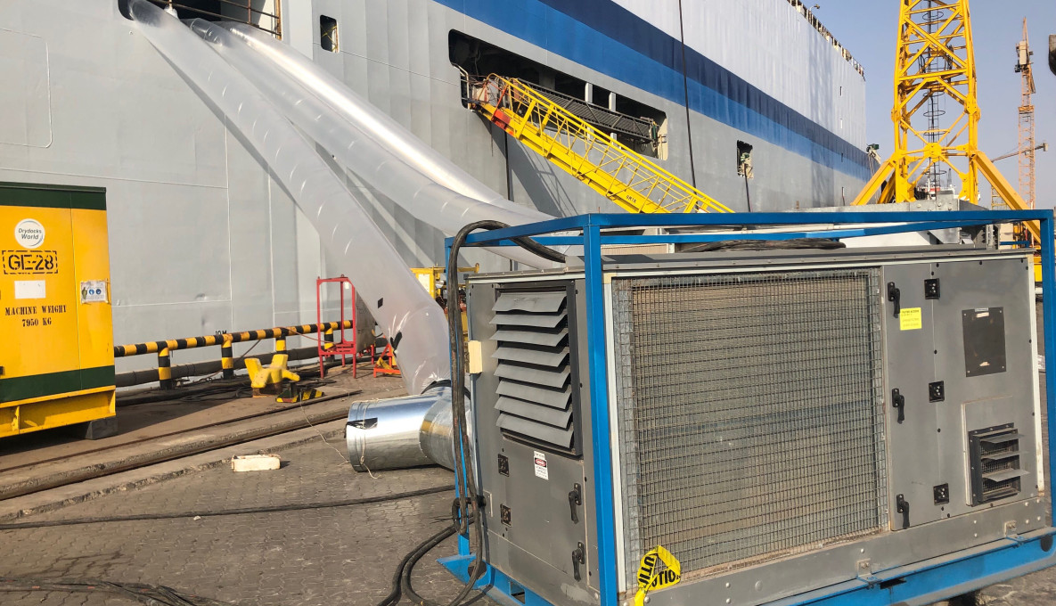 Large air conditioner with plastic tunnels going into a large livestock ship