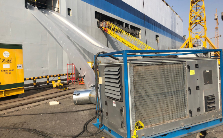 Large air conditioner with plastic tunnels going into a large livestock ship