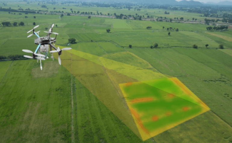 Areal shot of drone in the sky using terrain projecting scanning technology onto a field